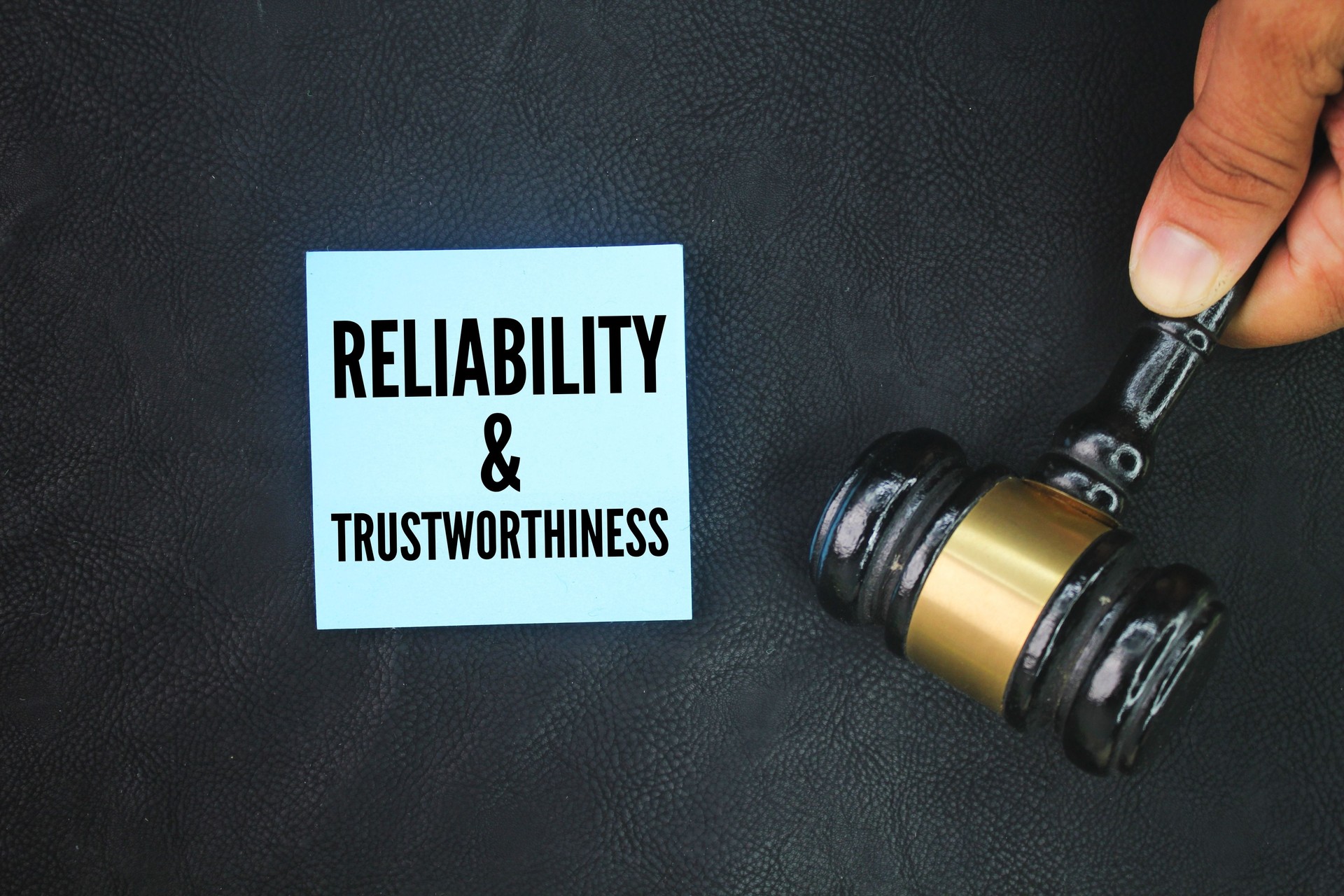Judge's gavel and paper with the words reliability and trustworthiness